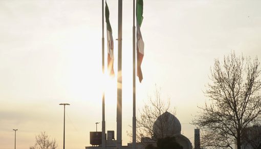mrmiix.com_a local mosque behind two Iranian flags