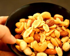 mrmix.com_Picking almond form mixed nuts in bowl stock video
